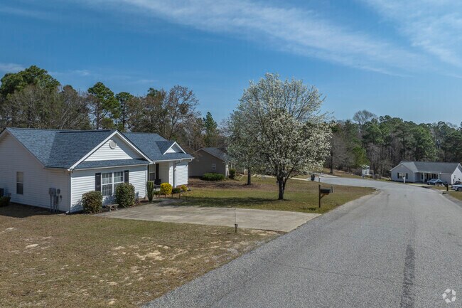 The neighborhoods with 1990s homes maintain a timeless charm with well-manicured lawns and tree-lined streets.