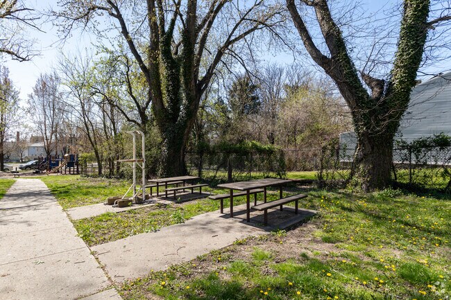 Sweets Fountain Park in Battle Monument features picnic tables, perfect for a day outdoors.