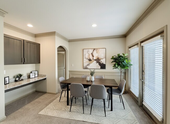 Living Areas Feature Curved Archways, Crown Molding, Wainscoting, and Built-ins
