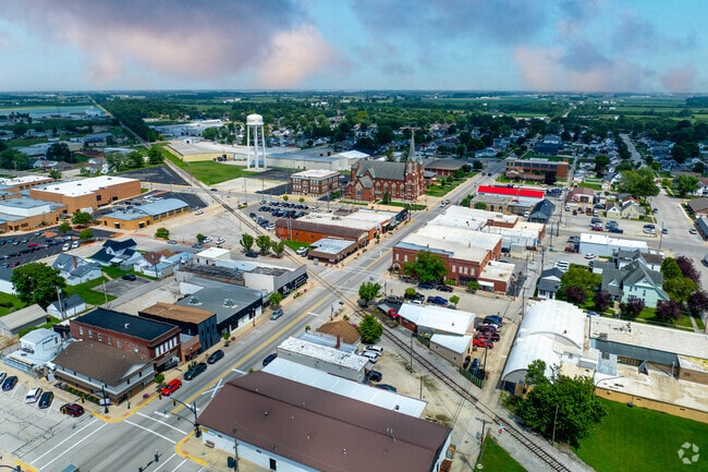 Coldwater’s main street and red brick church seen from above on a partly cloudy day.