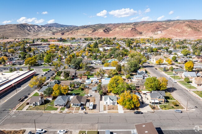 Richfield’s residential streets are framed by trees and rugged red rock hills.