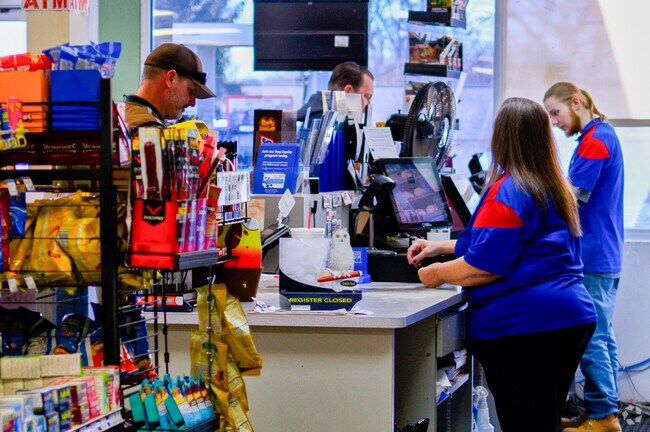 Friendly workers at the Vermontville Express help out a customer.