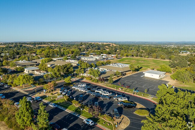 Kids run and play in the lush green fields of Parker Whitney Elementary School.