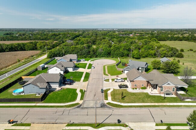 A cul-de-sac in Rose Hill features ranch-style homes with multicar garages and gabled roofs.