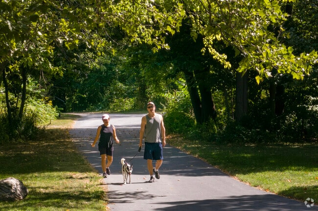 Residents of Brookdale take their dog for a walk on a sunny afternoon.