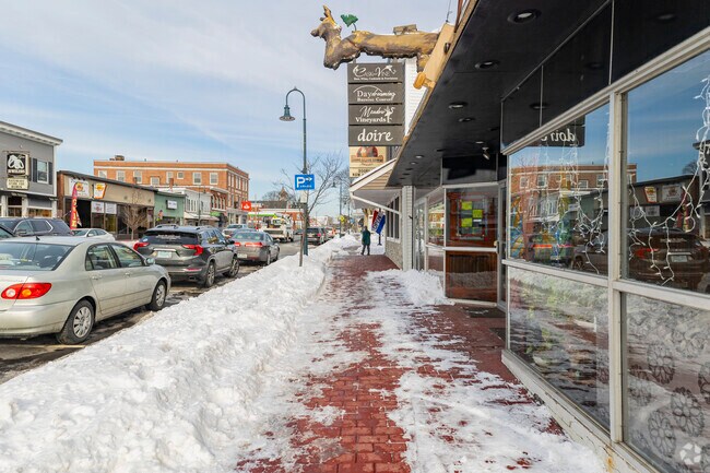 A street scene in Derry captures the town's character, with local shops, historic architecture, and daily life unfolding along its welcoming sidewalks.