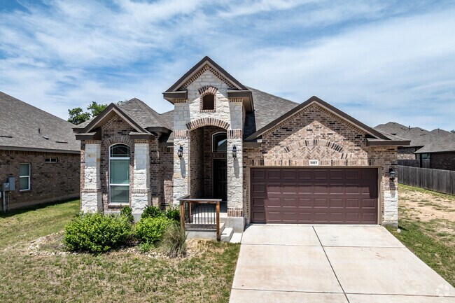 The new traditional style of this home is unique with brick arches in Blanco River District.