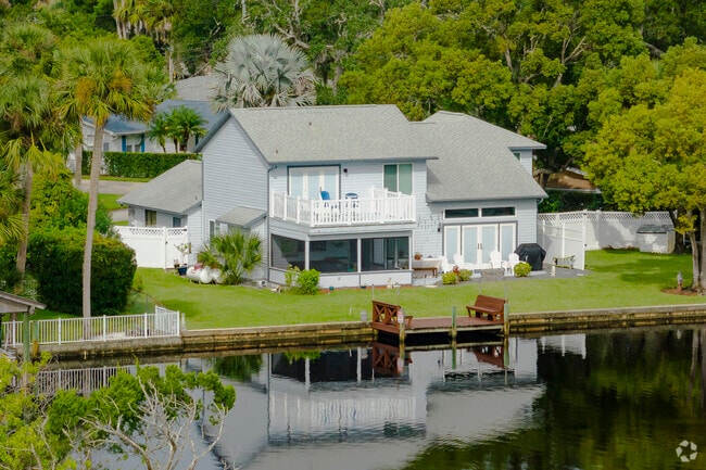 This sprawling home in the Tomoka Estates area has a spacious yard and direct, private river access.