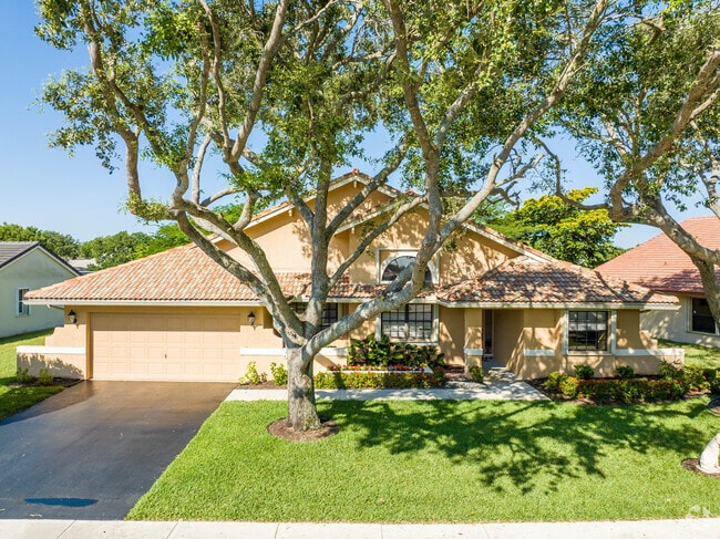 A cross-hipped roof home with a well-manicured lawn in the Forest Ridge neighborhood.