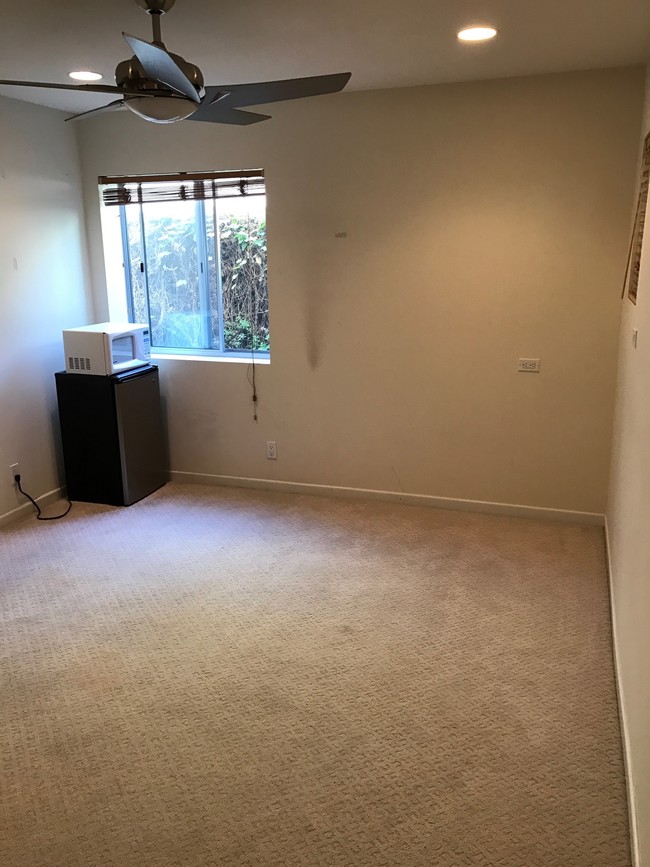 Bedroom with fridge & microwave.