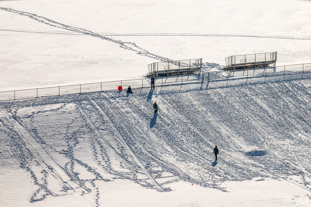 Kids come to Pulaski Middle School in Pulaski to sled down the sledding hill in Winter.