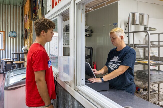 This Big Chimney young man is ordering a sandwich at Rollin Smoke BBQ.