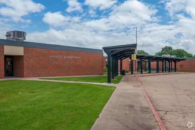 The entrance to Lincoln Elementary stands quiet beneath a summer sky in Pryor Creek.