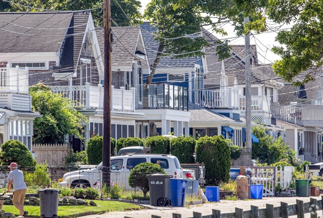 Original beach cottages line the road in Bay Spring, creating a charming street view.