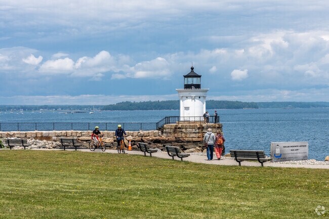 A large green space offers views of the historic Bug Light Park Lighthouse near Loveitts Field.