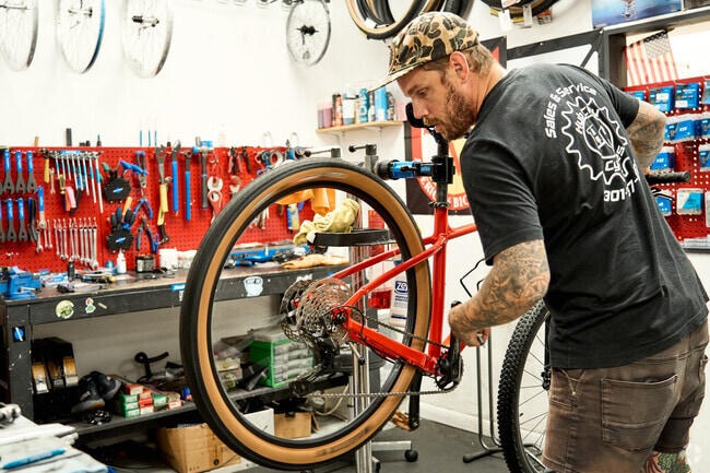 A bike technician works at Hub City Cycles, a local shop near Fountainhead-Orchard Hills.