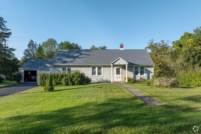 Rifton ranch style homes have attached garages with driveways and neat lawns.