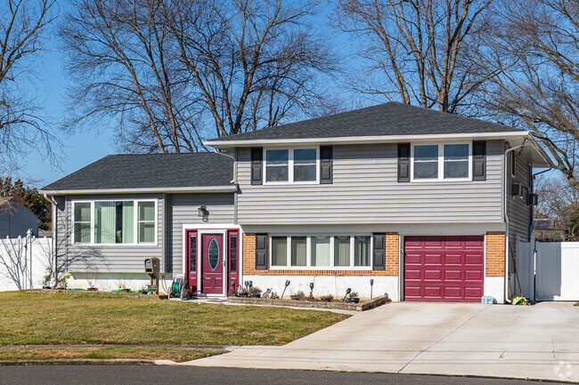 A house with a red door adds a touch of vibrant personality and charm to its exterior.