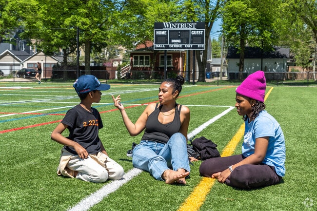 An Evanston family hangs out at Robert Crown Community Center on a sunny day.