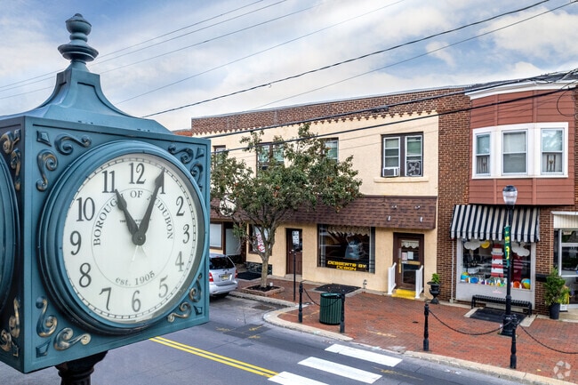 A town clock stands on Merchant Street in downtown Audubon.