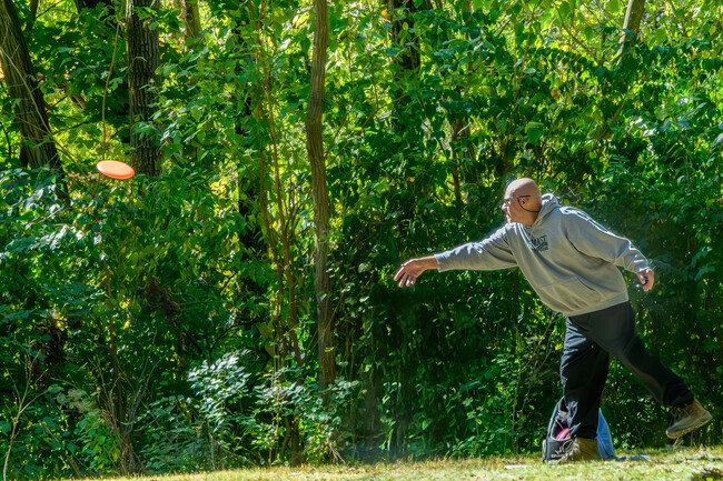 A man practices on the disc golf course in Murdock Park, located next to Perrin.