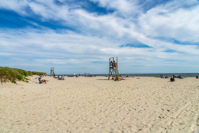 Folks soak up the sun and soft beach at Bank Street Beach near Harwich Center.
