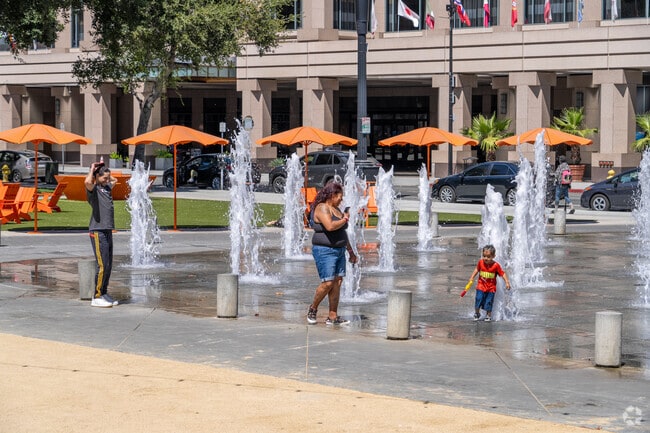 Families cool off at Plaza de Cesar Chavez’s playful water fountain in Downtown San Jose.