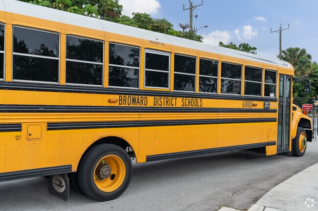A school bus waits to pick up students after school has ended.