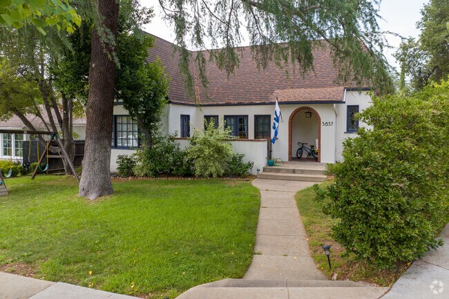 Charming small cottage in Verdugo Woodlands, adorned by a stately tree in the front yard.