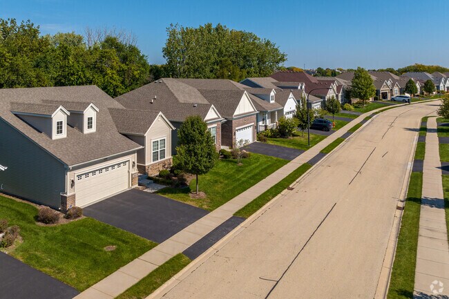 Two-story townhouses with shared backyards offer both privacy & community in Carillon Club.