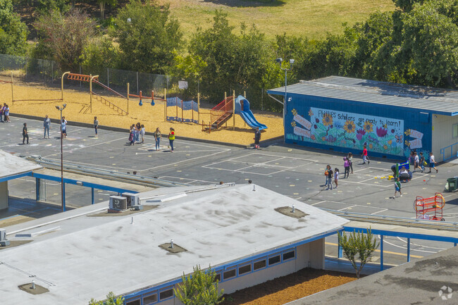 Phillips Elementary has a large blacktop area with some playground structures.