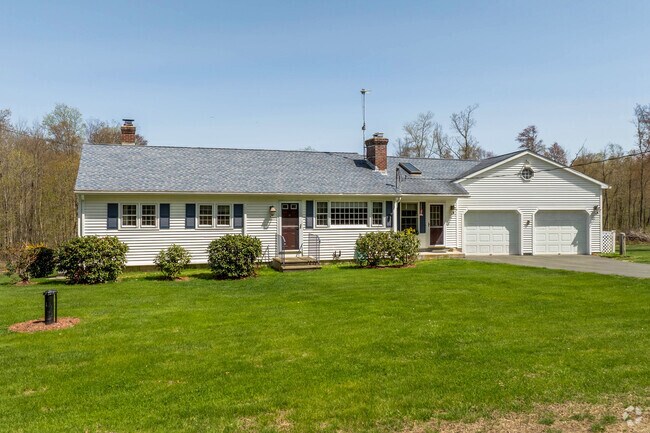 A white ranch style home in Hampton has a two-car attached garage and black shutters.