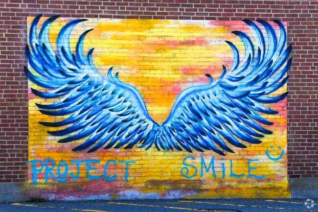 A mural on the back of Town Hall in Millis invites everyone to smile.