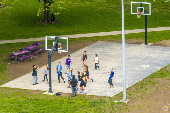 The basketball court of Washington Park provides a central gathering spot for all ages.