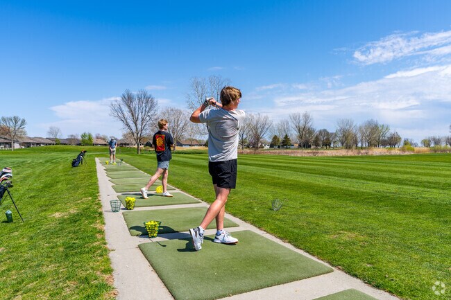 Golfers can practice at the driving range at The Bluffs Golf Course.