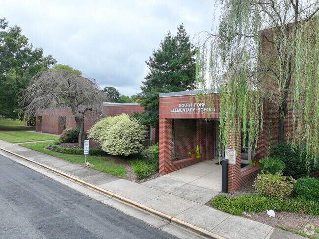 The entrance to South Fork Elementary School is surrounded by beautiful greenery.