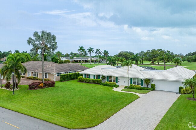 Single family homes have large front yards and driveways in Atlantis neighborhood.