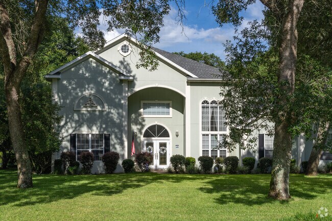 This Neoclassical style home sits on a spacious lot in Rocky Bayou Estates.