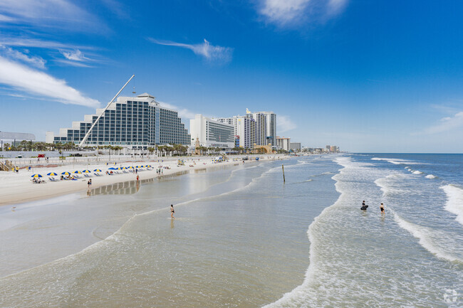 Daytona Beach Shores has small waves with blue water.