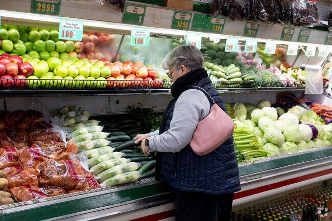 A woman shops for some produce at El Novillo Market in Sun Village.