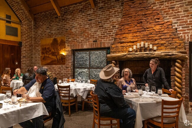 Postino clients love the large fireplace and red brick area for dining in Downtown Lafayette near Peardale Estates.