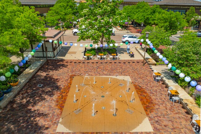 The sparkling fountains at Orchard Town Center add a playful note to Lewis Pointe in Thornton, Colorado. Families gather to cool off, shop, and savor the energy of this vibrant neighborhood hub.