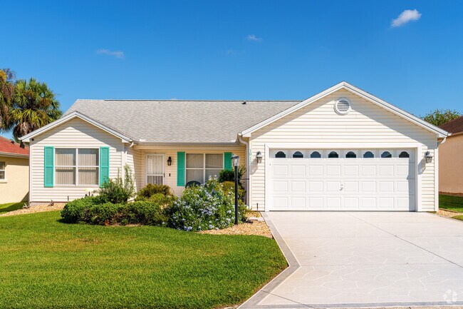 Teal shutters add a pop of color to this charming home in the Village of Palo Alto.