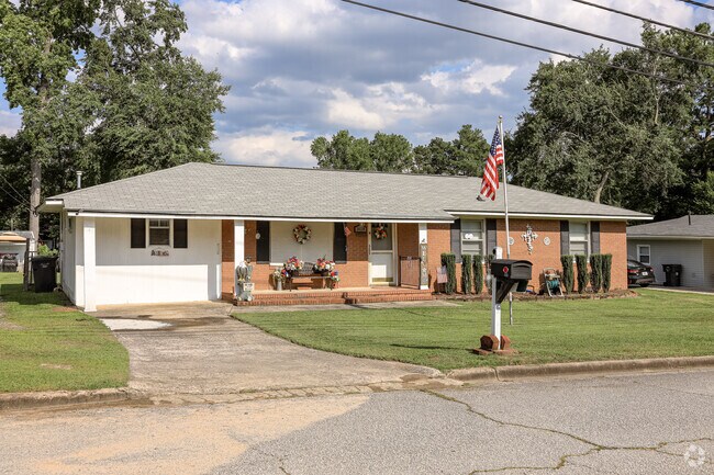 Colorful landscaping and an American flag on display at this North Leg Augusta home.