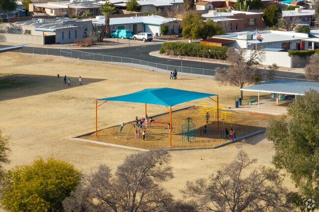 Gale Elementary School children play under shade.