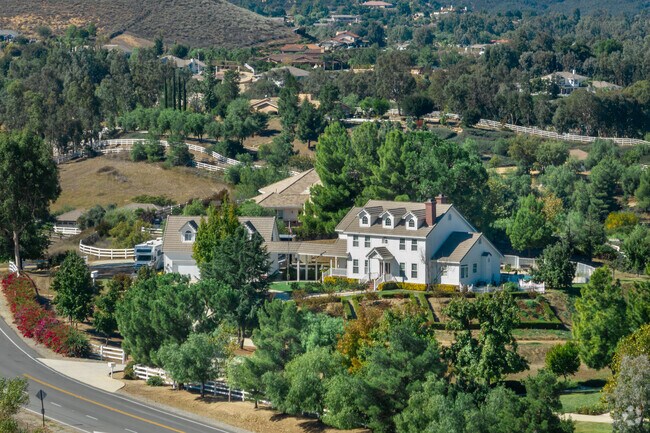 Trees surround a home built in a classic American style in La Cresta.