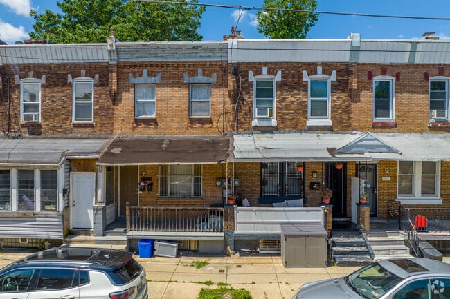 Escape the summer heat under the covered front porch of a Mill Creek row home.