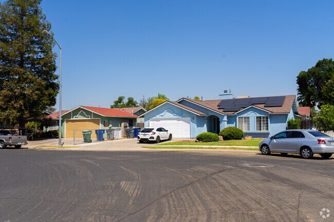 A row of minimal traditional homes lines a peaceful street in North Madera.