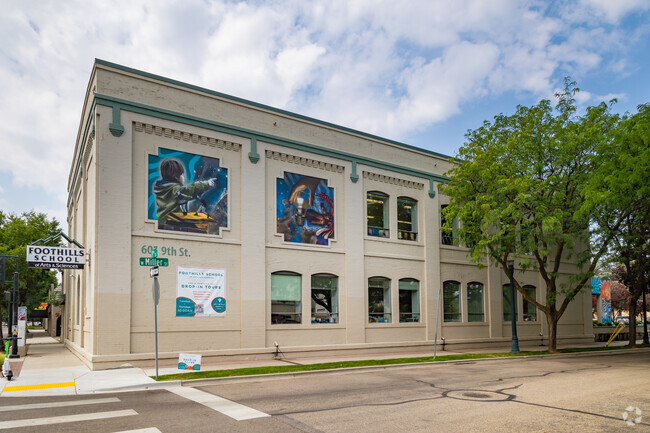Artists create colorful murals on the building for the Foothills School of Art and Science.