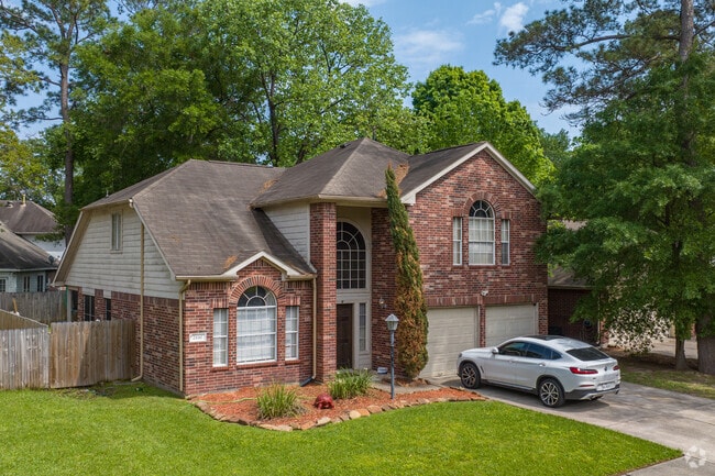 A split-level home sporting a grand entranceway and beautiful trees in Spring.